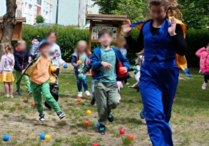 Uciekająca tarcza (animatorka) i goniące ją z piłkami dzieci.